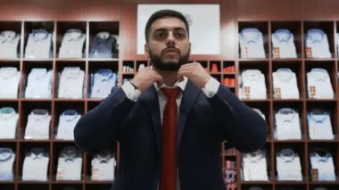 Takım elbise dükkanından klasik takım elbise seçen bir iş adamı.