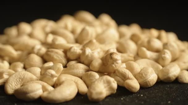 Pile of Cashew Nuts on black background — Stock Video