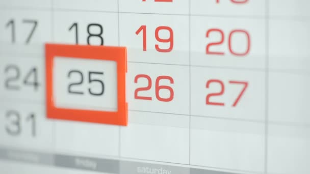 Womans hand in office changes date at wall calendar. Changes 25 to 26 — Stock Video