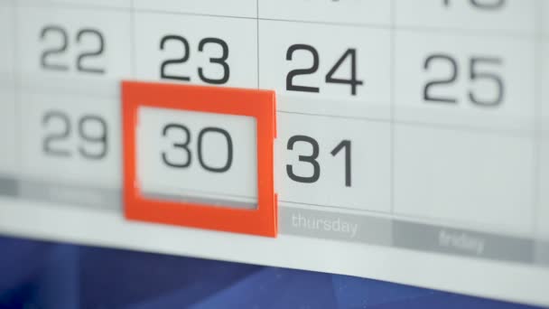 As mulheres entregam a data de modificações de escritório no calendário de parede. Alterações 30 a 31 — Vídeo de Stock