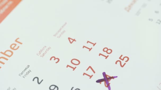 Woman hand cross day on paper calendar. 25st day of the month — Stock Video