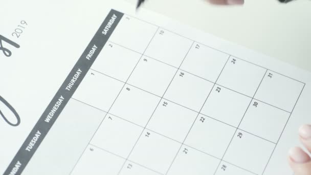 Женский почерк с красной войлочной ручкой на календаре — стоковое видео