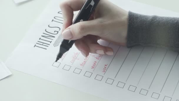 Mano femminile mettendo il segno sulle caselle di controllo di do list — Video Stock