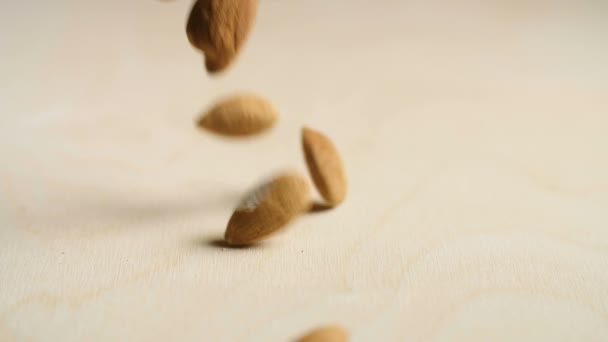 Almonds Falling on a wooden table — Stock Video