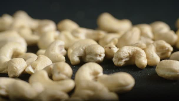 Pile of cashew nuts isolated on black — Stock Video