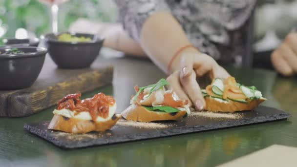 Manos tomando deliciosa bruschetta para comer — Vídeo de stock