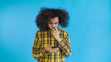 Genç üzgün Afro-Amerikalı adam telefonu kullanıyor ve mavi arka plandan kötü haberler alıyor. Duyguların kavramı