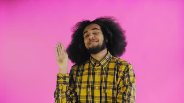 Young Afro-American man showing silence or bla bla gesture on purple background. Concept of emotions — Stock Video