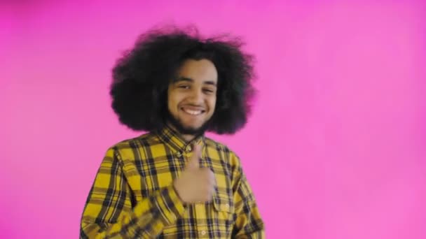 Giovane felice afro americano uomo sorridente, mentre dando pollici su su sfondo viola. Concetto di emozioni — Video Stock