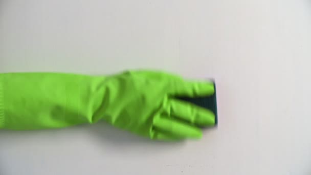 Top view of Hand in green glove is Cleaning Surface With dark Sponge — Stock Video