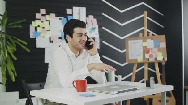 Jonge zakenman praat op mobiele telefoon en lacht — Stockvideo