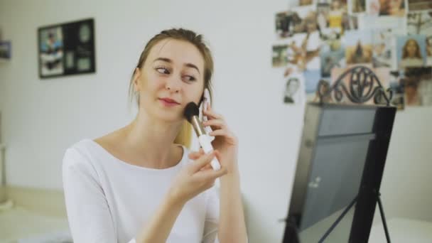 女は電話で化粧をしてる — ストック動画
