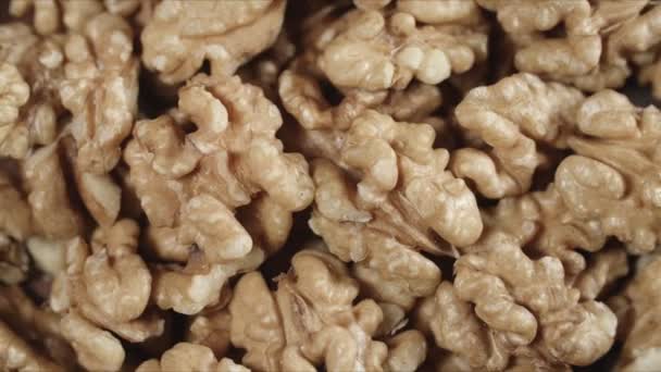 Dry walnut background, close up nut, rotation top view. Food background — Stock Video