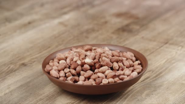 Woman Picks Up a handful of peanuts, To Eat, From Her Bowl. took a nut on the left side — Stock Video