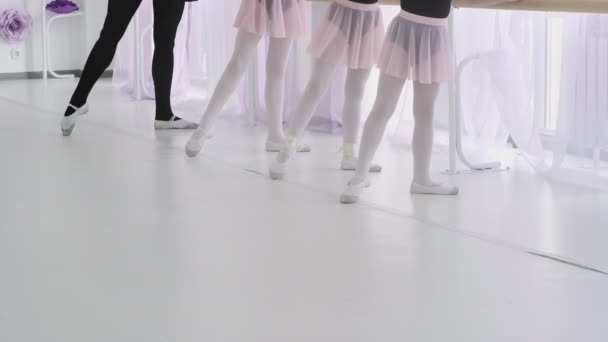 Balerina kecil mengulangi gerakan dengan guru. pelajaran balet di studio — Stok Video