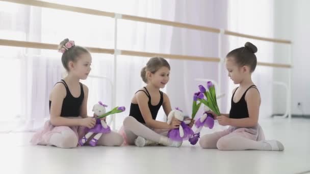 Маленькие балерины играют с игрушками во время перерыва — стоковое видео
