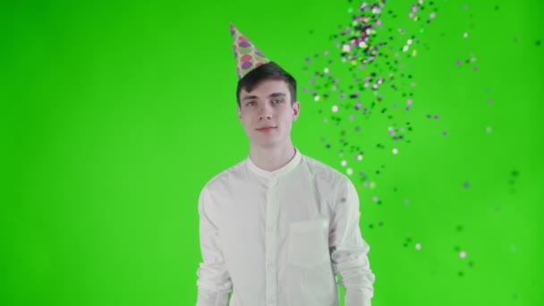 Confetti was thrown at the young man on a green screen . Slow motion — Stock Video