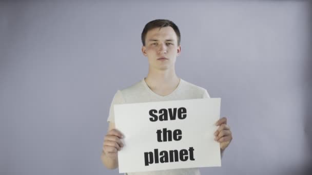 Young Man Activist With Save The Planet Poster on grey background — Stock Video