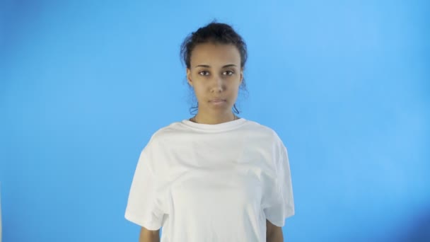 Krásná mladá žena s hroznou bolest hlavy na modrém pozadí — Stock video