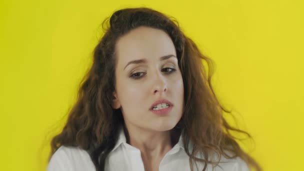 Portrait of discontent woman expressing aversion and demonstrating her disgust in Studio with yellow Background. — Stock Video