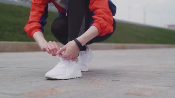 Fiatal sportos női cipőfűző futás előtt — Stock videók