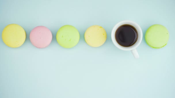 Makaroner eller makaroner på pastellblå yta med espresso i vit kopp. — Stockvideo