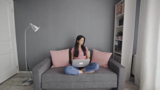 Thoughtful concerned woman working on laptop computer looking away thinking solving problem at home office, serious woman search for inspiration make decision feel lack of ideas — Stock Video