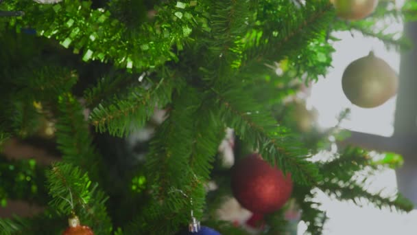 Mains de femmes Décoration sur sapin de Noël avec boule jaune.