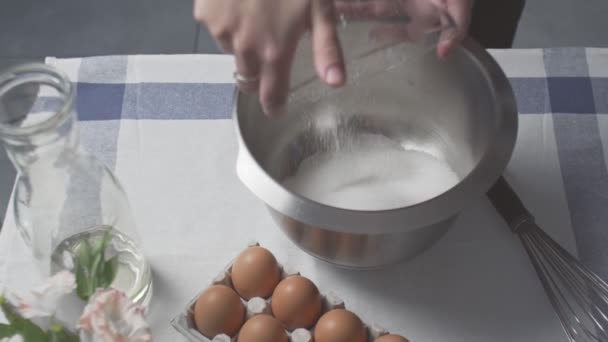 Professional chef is cooking cake. Young attractive housewife puts sugar and oil to metal bowl — Stock Video