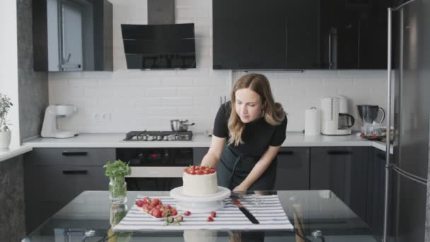 Profi-Koch kocht Kuchen. Junge attraktive Hausfrau kocht den Kuchen und bewundert ihn — Stockvideo