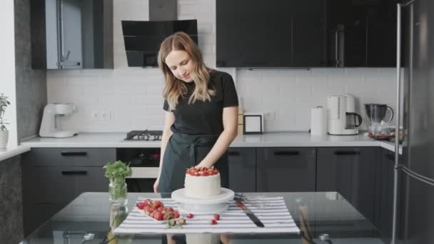 Professional chef is cooking cake. Young attractive housewife finished cooking the cake and admiring it — Stock Video