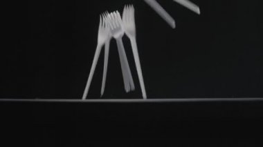 Beyaz çatallar siyah arka plan yavaş çekim videosuna düşer.