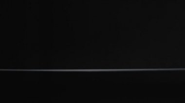 Beyaz çay kaşığı siyah arka plan yavaş çekim videosuna düşer.