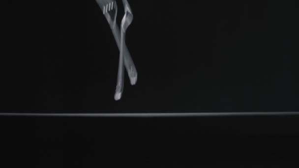 Transperent forks falls on black background slow motion vídeo. — Vídeo de Stock
