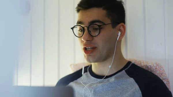 CLose up of Man deitado em uma cama e falando em uma câmera web e sorrindo — Fotografia de Stock