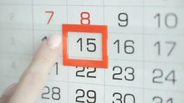Kvinna hand i kontor ändrar datum på vägg kalender. 15 — Stockfoto