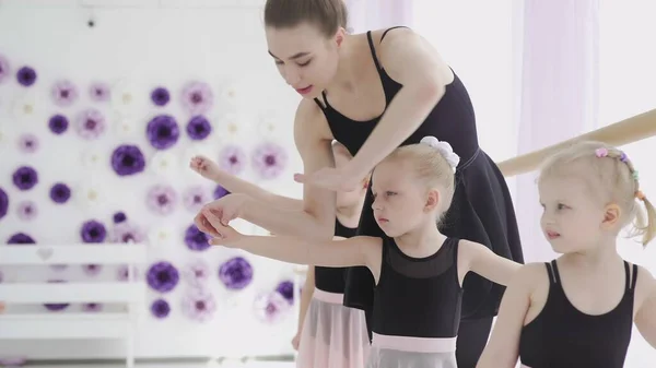 Children and teacher at the ballet school. Lesson of classical ballet in a dance school.