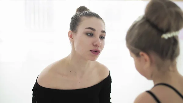Cute Female ballet teacher gives his sad student a toy to calm her — Stock Photo, Image