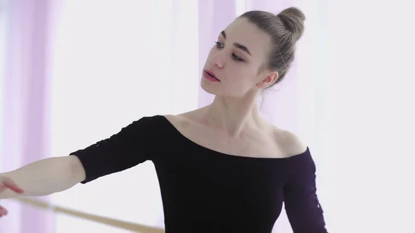 Close up of Professional ballet dancer practicing near a ballet bar. — Stock Photo, Image