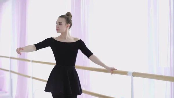 Professional ballet dancer practicing near a ballet bar — Stock Photo, Image