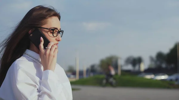 Attractive business woman talking on the smartphone while walking to meeting or office — Stock Photo, Image