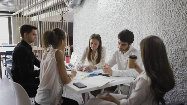 Young hipster business group working together and brainstorming for ideas in loft office. — Stock Photo, Image