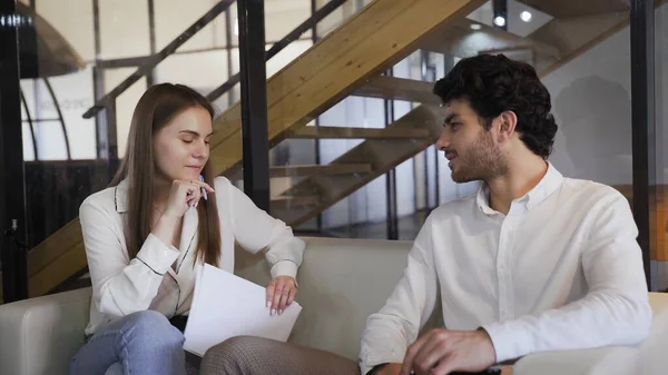 Young woman interviews man in modern office — Stock Photo, Image