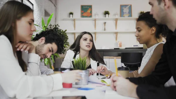 Female team leader at office meeting. Young multiethnic business people brainstorm in trendy coworking — Stock Photo, Image
