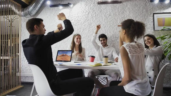 Business team celebrating a good job in office. throwing paper documents, dancing and giving high five — Stock Photo, Image