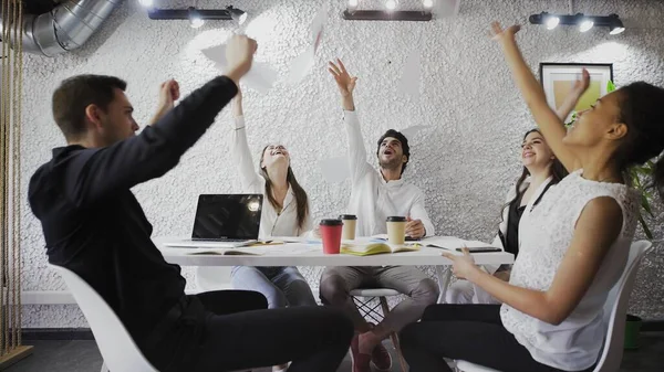 Business team celebrating a good job in office. throwing paper documents, dancing and giving high five — Stock Photo, Image