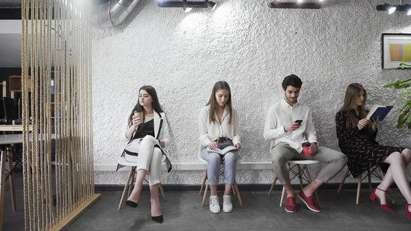 Diverse applicants waiting for their turn sit in line — Stock Photo, Image