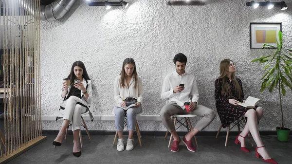 Jobless applicants group sitting in queue waiting for job interview — Stock Photo, Image