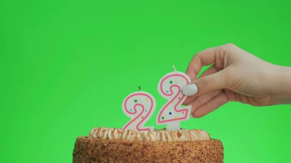 Anzünden einer Geburtstagskerze Nummer vier auf einem leckeren Kuchen, grüne Leinwand 22 — Stockfoto