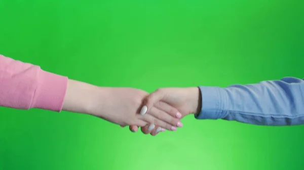 Friends shaking hands. Handshake wiht two hands, keyed green screen